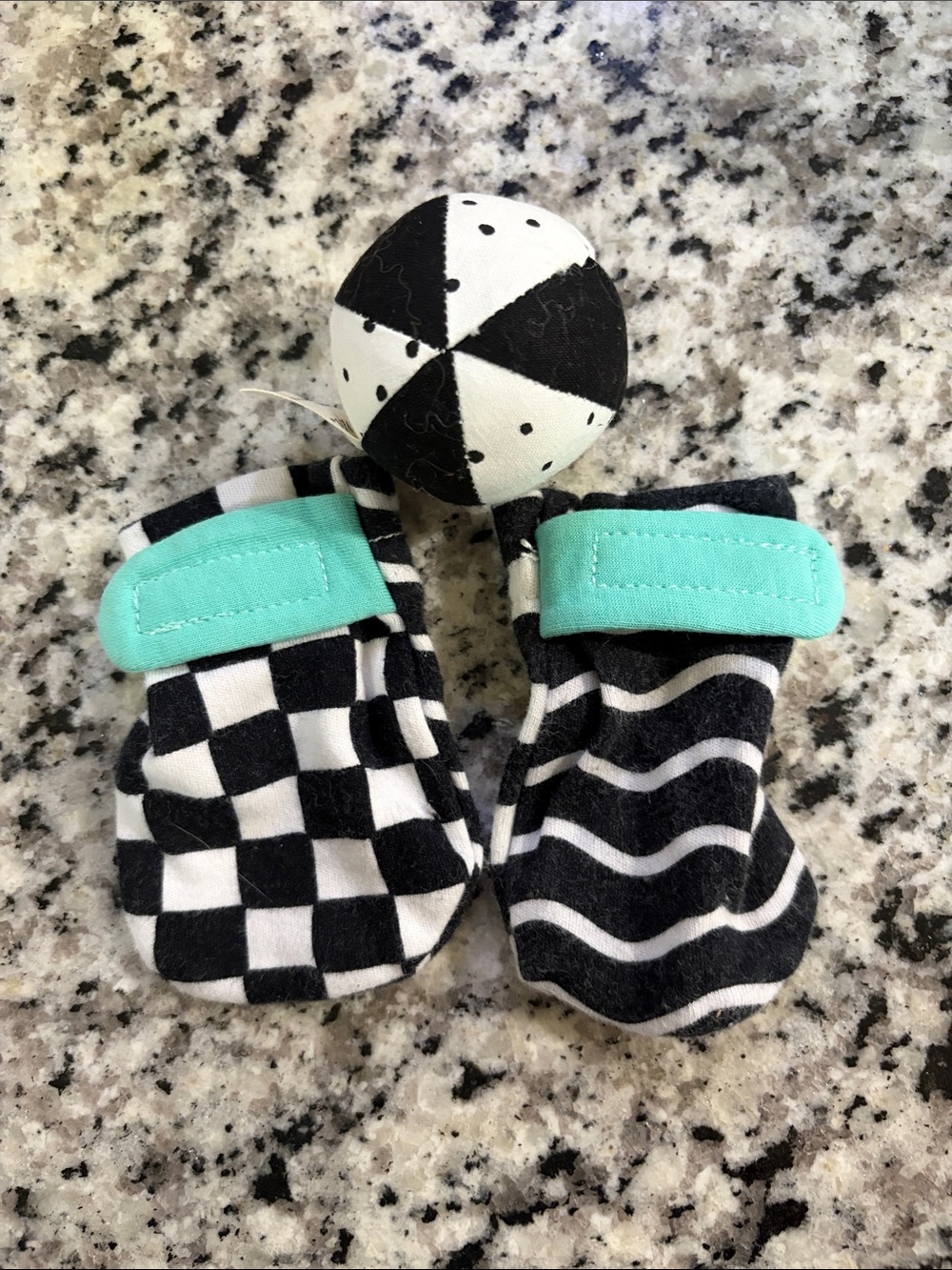 Lovevery Black & White Sensory Baby Mittens with Mint Velcro
